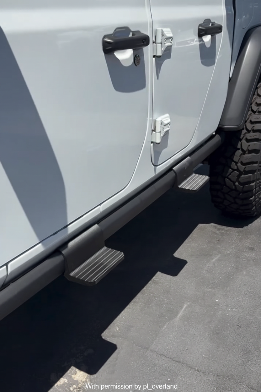Two ZR2Steps installed on the factory rail of a silver Jeep